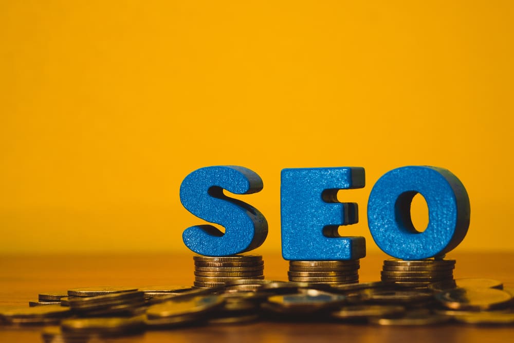 SEO money concept - image of stacked dollar bills with SEO text, representing making money with SEO marketing strategies.